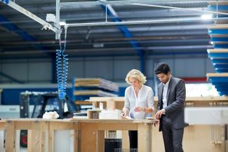 business-people-reviewing-documents-in-workshop-station