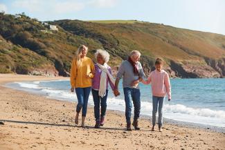 family walking on the beachfront